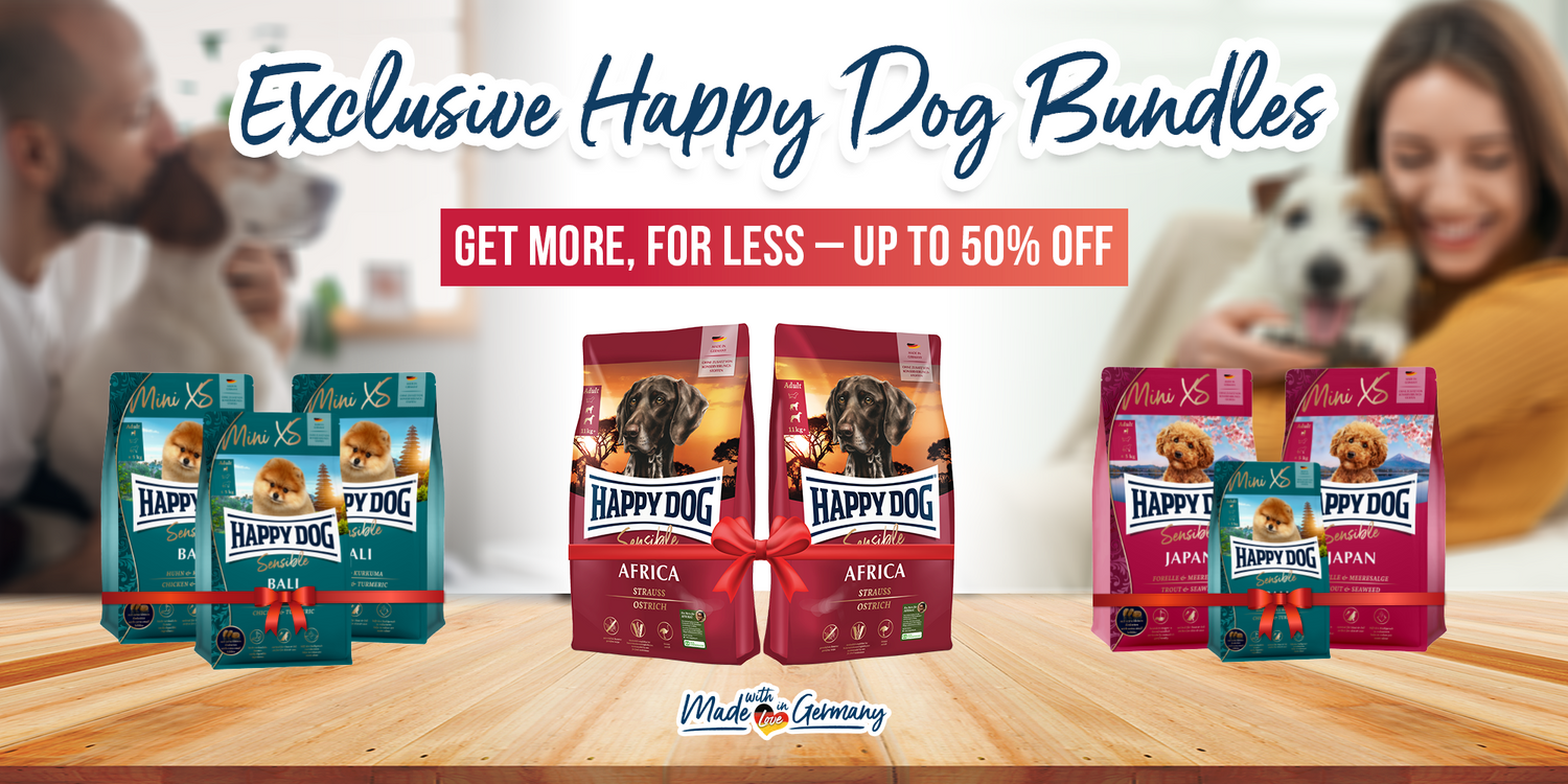 Happy Dog pet food packages on a wooden table with promotional text.